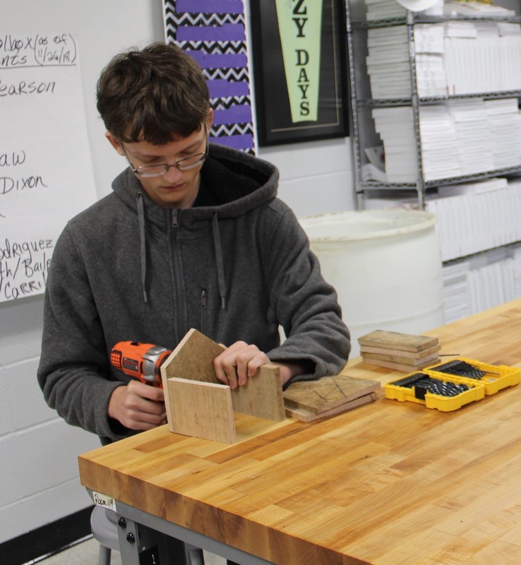 Sophomore John Ramsey attaching the walls his bird house together.