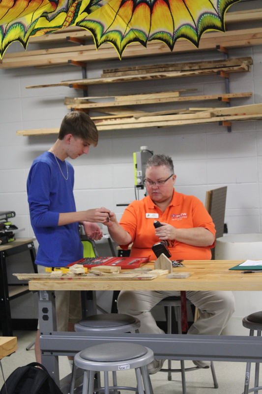 Sophomore Ethan Winer learns how to change a drill bit from Ms. Philyaw.
