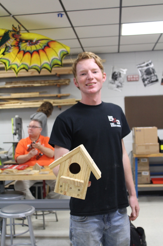 Trenton Bailey shows off his finished bird house.